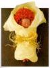 baby in bouquet of flowers